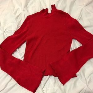 Red turtleneck with bell sleeves